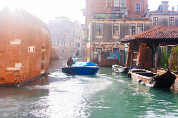 Venetian channel with ancient houses and boats
