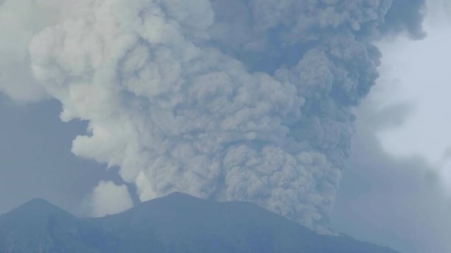 Ash plume rising from Agung volcano crater during explosive eruption in Bali, Indonesia