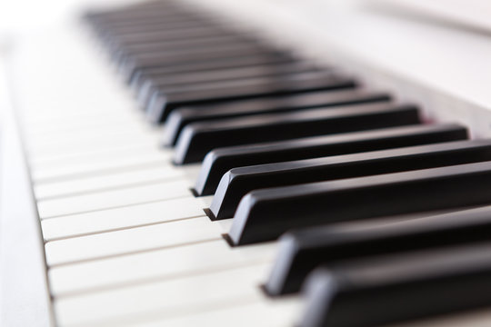 Close up of black and white piano keys.