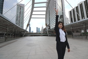 Leadership woman, Attractive young Asian businesswoman raising hands outdoors