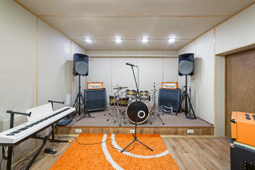 Sound rehearsal studio room with drum kit.