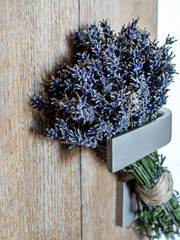 Bunch of lavender hanging on door handle.