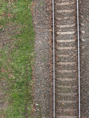 View from above on railway track with green grass