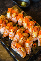 Sushi salmon cheese stack with shrimp eggs on dish in restaurant,Japanese food style,Selective focus