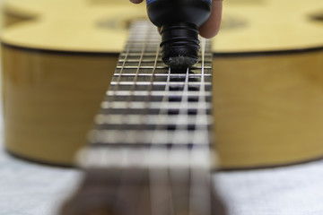 Maintenance of the strings of a guitar.