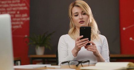 Attractive blonde woman working in the urban office.