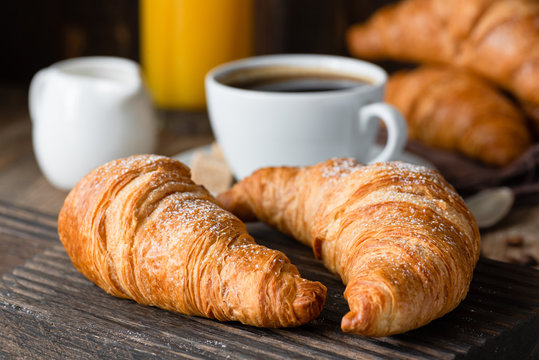 Croissants, coffee and orange juice. Continental breakfast. Closeup view