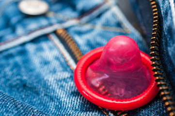 Red condom in jeans 