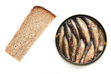 Full open round tin jar of canned golden smoked Baltic sprats in oil and slice of wheat bread. Top view. White background. Isolated 
