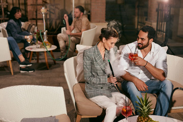 Romantic Couple In Restaurant With Shisha And Cocktails