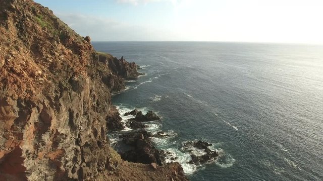 Flyover of Ocean cliff, steep rocky coastline - San Benedicto Island