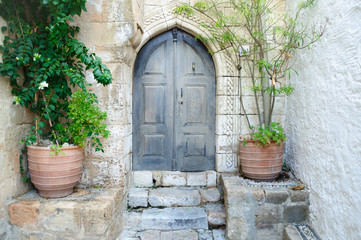 Fototapeta na wymiar Old wooden door in stone house.