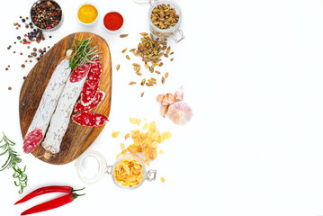 Sliced cured sausage with a sprig of rosemary.