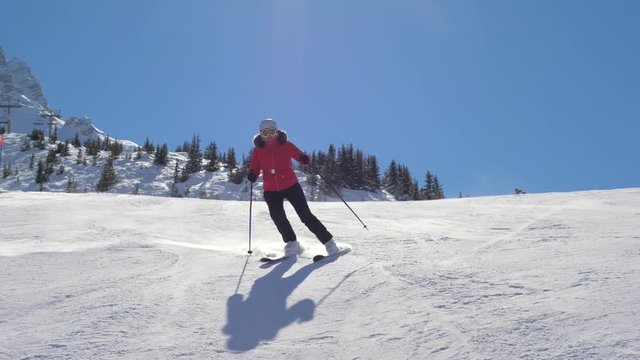 Skier Skiing Down Carving On The Slope In The Mountains In Winter