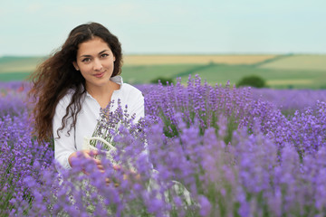 young woman is in the lavender field, beautiful summer landscape with red poppy flowers