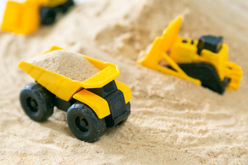 Construction concept - toy model machinery on sald