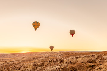 View of Hot air balloons flying in sunset sky