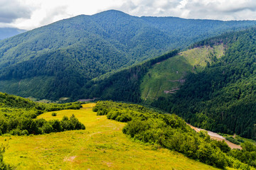 Fototapeta na wymiar beautiful landscape on the Carpathian mountains with a river in the valley over which the shadows of clouds