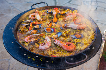 Traditional Spanish paella with seafood and chicken in a pan