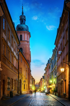 Fototapeta Warsaw old town street. Evening view of old houses and Church. Long exposure. Warsaw, Poland.
