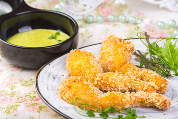 Fried frog legs on plate with lemon sauce food concept