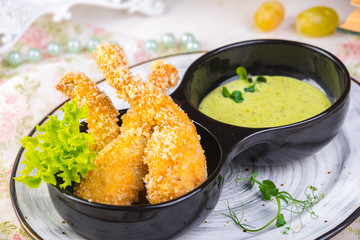 Fried frog legs on plate with lemon sauce food concept