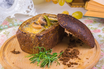 Homemade mushroom cream soup, served in bread bowl