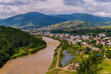 Carpathian mountain river flowing near the village
