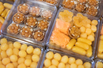 Thai style desserts in plastic boxes.