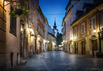 Fototapeta na wymiar Old Ljubljana cityscape cobbled street evening view. Ljubljana capital of Slovenia.