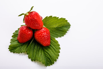 Juicy fresh strawberry on a white acrylic background