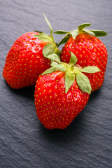 juicy fresh strawberry on a dark stone background