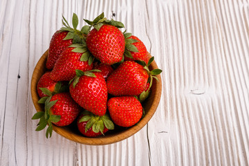 Juicy fresh strawberry on a rustic wooden background