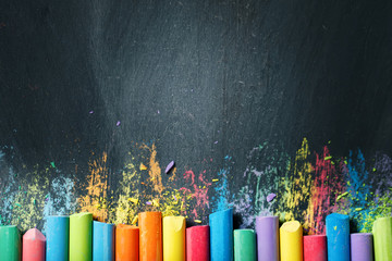 Colorful crayons on the blackboard, drawing. Back to school background. - obrazy, fototapety, plakaty