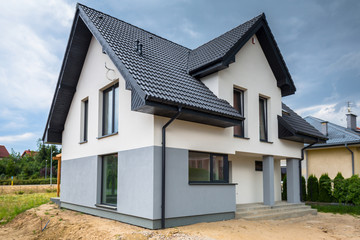 Newly built house with a finished plaster and paint - obrazy, fototapety, plakaty