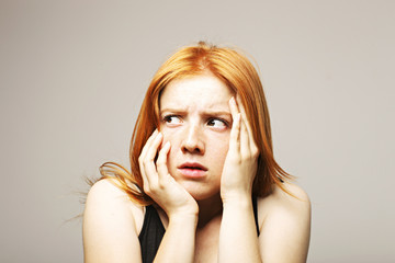 Beautiful fragile redheaded young woman in the dark. Sad frightened girl scared of abuse. Nonverbal...