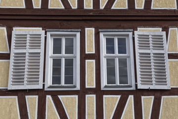 Two windows with wooden shutters