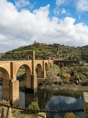 Naklejka premium Beautiful view of the Alcantara Bridge, a Roman stone arch bridge built over the Tagus River, in Extremadura, Spain. March, 2018