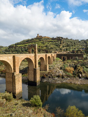 Beautiful view of the Alcantara Bridge, a Roman stone arch bridge built over the Tagus River, in Extremadura, Spain. March, 2018