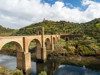 Fototapeta na wymiar Beautiful view of the Alcantara Bridge, a Roman stone arch bridge built over the Tagus River, in Extremadura, Spain. March, 2018