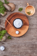 cosmetic cream and fresh lavender leaves on white wooden table background