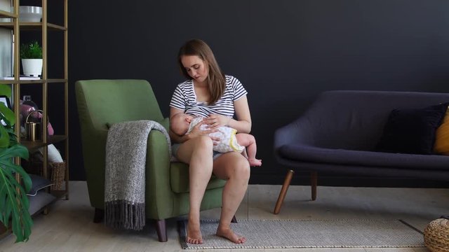 Newborn baby being breastfed by mother