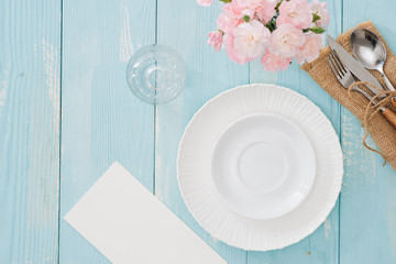 Table setting with plate, fork and knife on wooden background