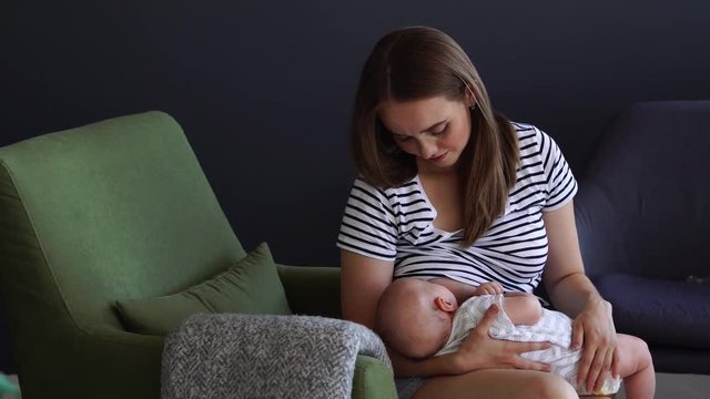 Newborn baby being breastfed by mother
