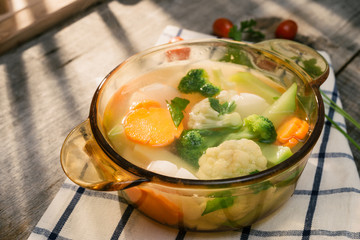Assorted vegetables in glass pot on a napkin close up