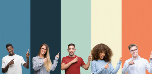 Group of people over vintage colors background smiling and looking at the camera pointing with two...