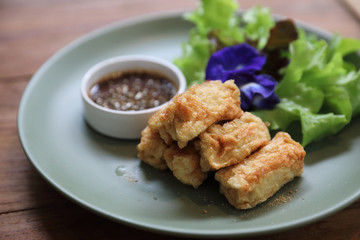 Vegan food appetizer japanese fried tofu on wood background vintage style