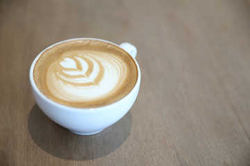 cappuccino or Latte art coffee made from milk on the wood table in coffee shop