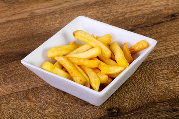 French potato over wooden background