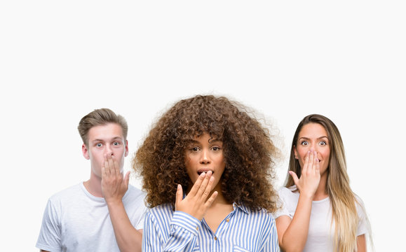 Group of young people over white background cover mouth with hand shocked with shame for mistake, expression of fear, scared in silence, secret concept